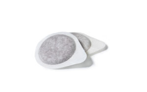 Coffee Pod/Capsule for Italian Espresso Machine, Close-Up of a Pair, Disposable and Compostable Filter Paper – Isolated on White Background